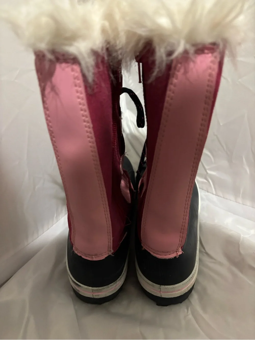 The image shows the black rubber lug outsole of an Ozark Trail kids' winter boot